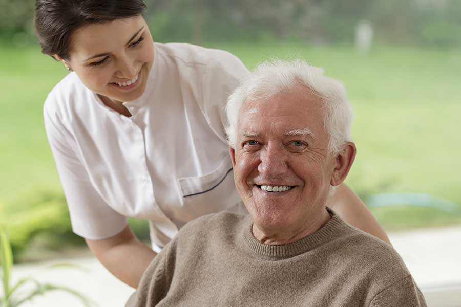 elderly-man-and-caregiver-in-white